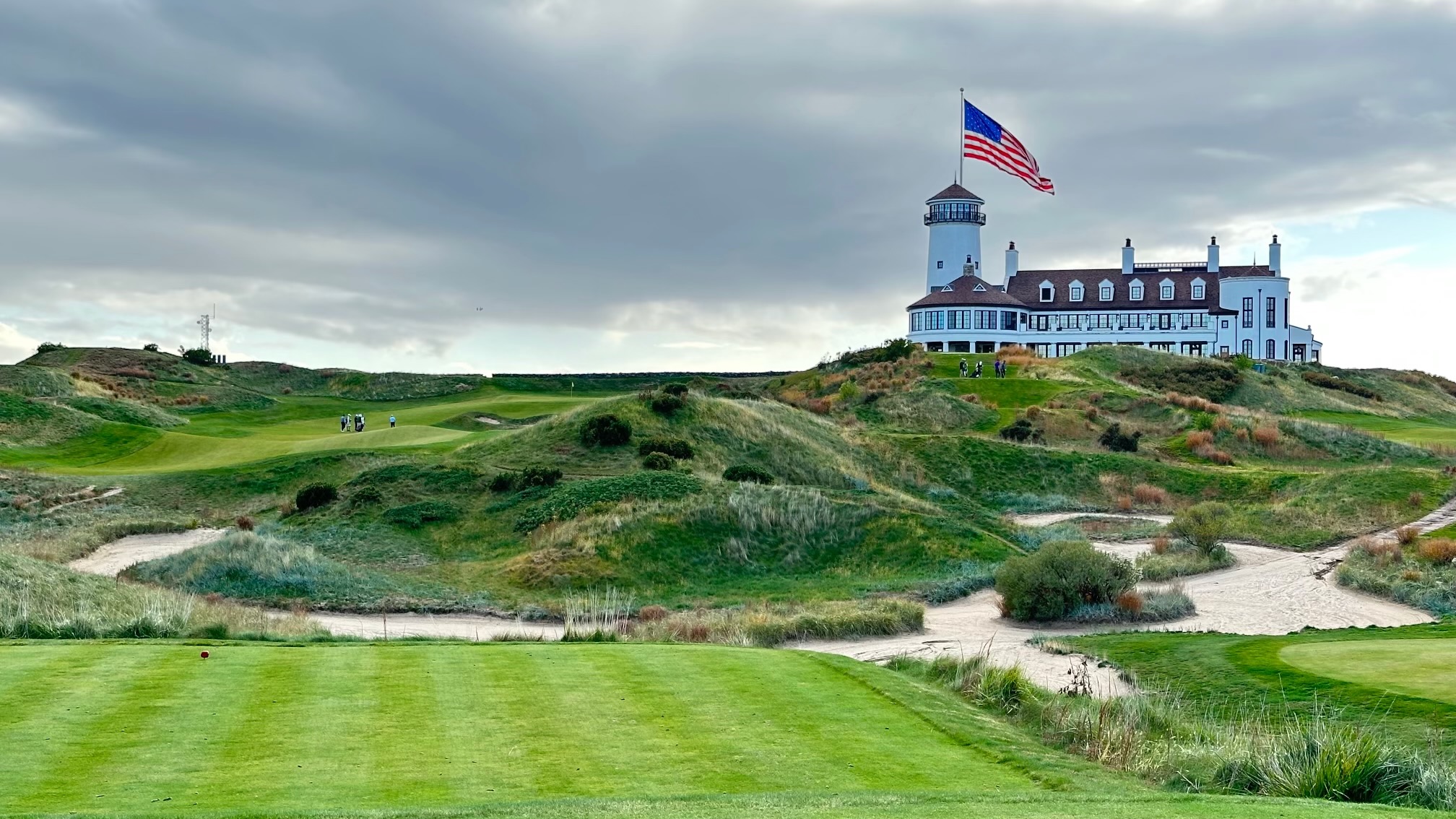 Golf course and clubhouse under a blue sky